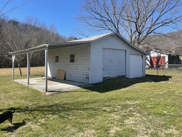 view of outdoor structure featuring an outbuilding and fence