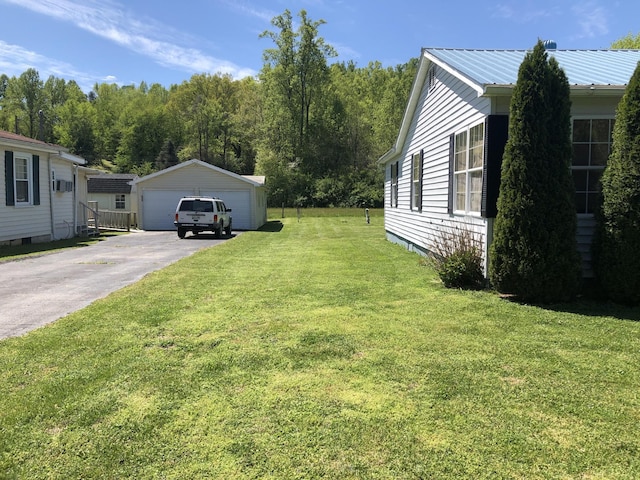 view of property exterior featuring metal roof, an outdoor structure, a detached garage, and a lawn