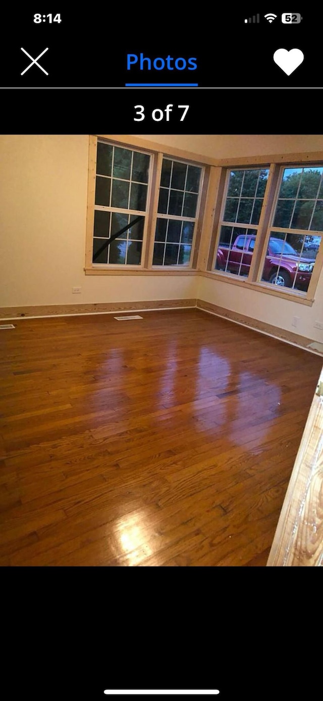 empty room with wood finished floors and baseboards