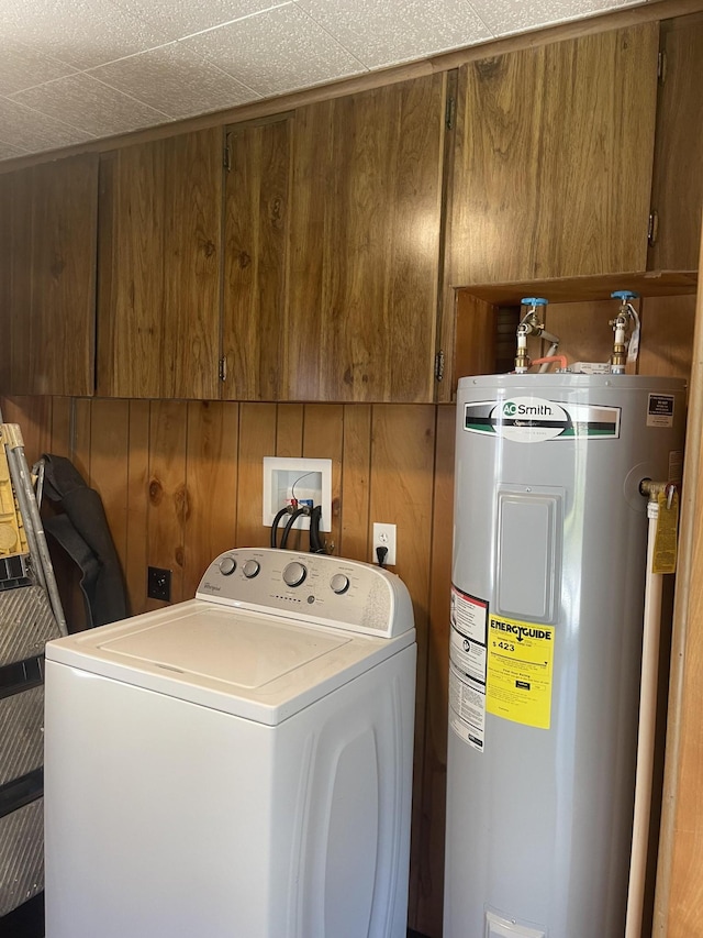 washroom featuring washer / dryer, wood walls, cabinet space, and electric water heater