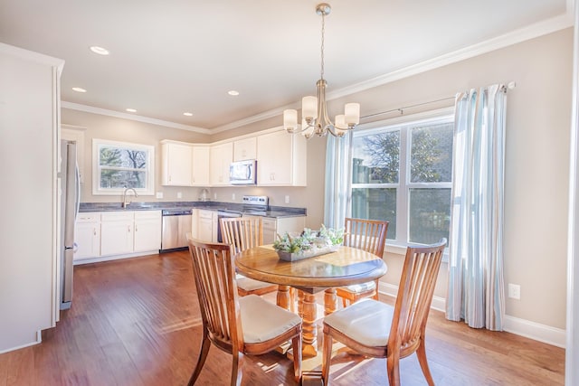 127 Odie Ray St, Gallatin, TN 37066 - dining room featuring baseboards, light wood finished floors, a notable chandelier, and crown molding