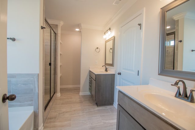 full bath with two vanities, a stall shower, crown molding, and a sink