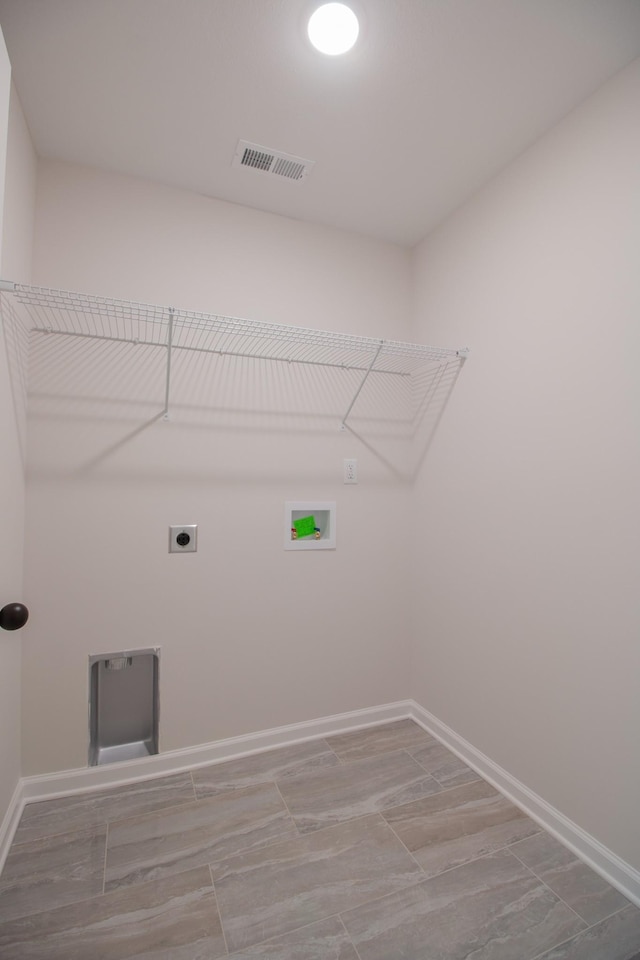 washroom with electric dryer hookup, visible vents, baseboards, hookup for a washing machine, and laundry area