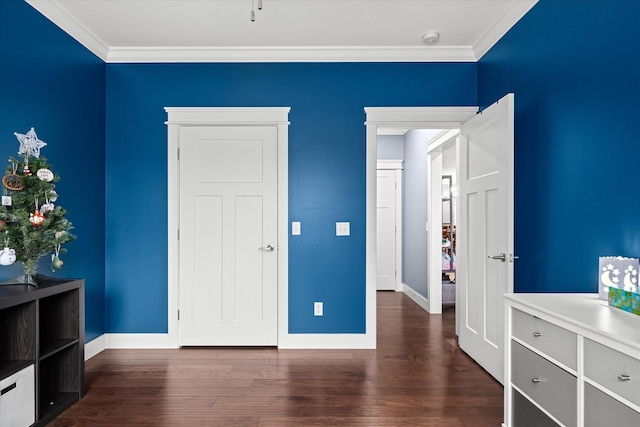 unfurnished bedroom with baseboards, dark wood-type flooring, and crown molding