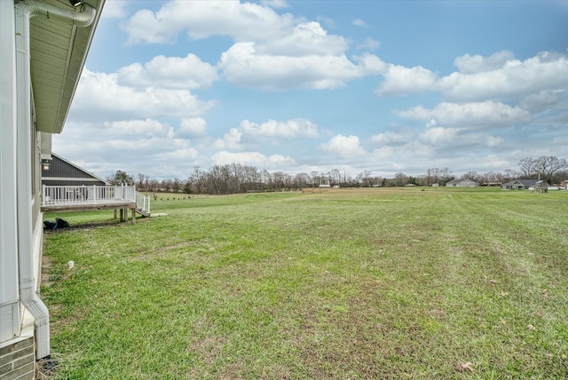 view of yard featuring a deck and a rural view