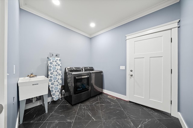 laundry room featuring laundry area, baseboards, washer and clothes dryer, marble finish floor, and crown molding