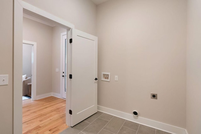 clothes washing area featuring laundry area, baseboards, electric dryer hookup, and wood finished floors