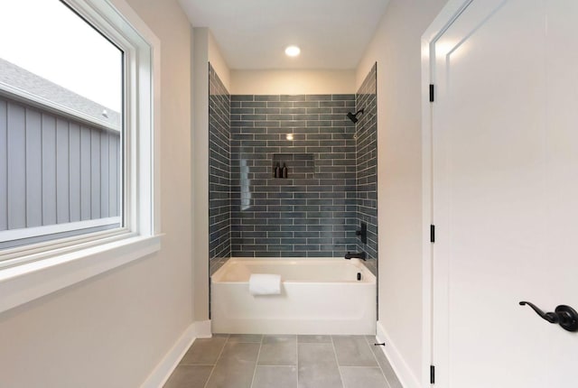 bathroom featuring tile patterned floors, baseboards, and shower / bathtub combination