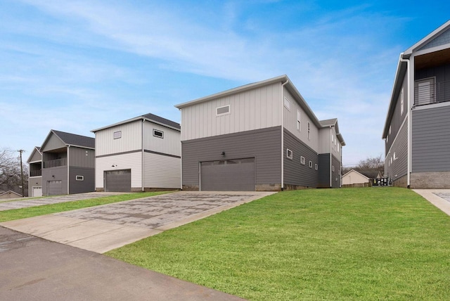 exterior space with a garage, concrete driveway, board and batten siding, and a front lawn