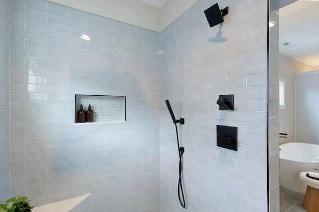 full bath featuring a walk in shower, a freestanding bath, and visible vents