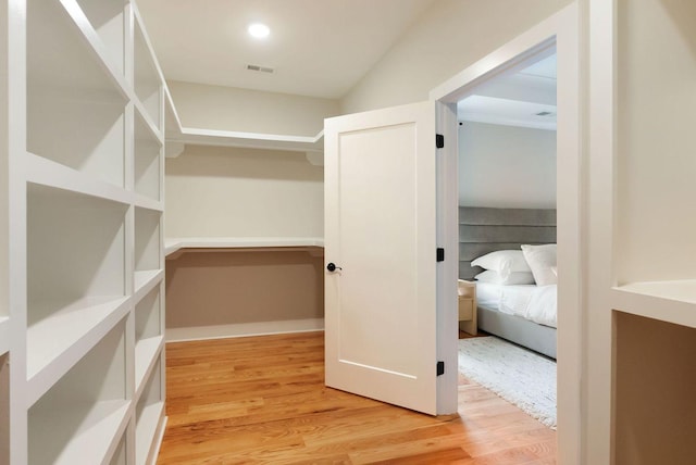 walk in closet featuring light wood-type flooring and visible vents