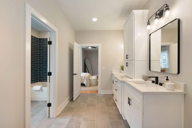 full bathroom featuring tile patterned floors, baseboards, and vanity