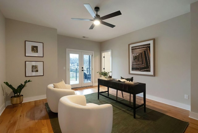 home office featuring french doors, light wood-type flooring, and baseboards