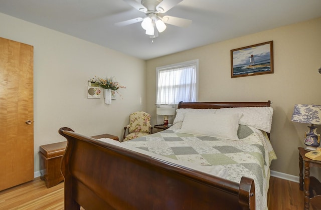 bedroom featuring light wood-type flooring, baseboards, and a ceiling fan