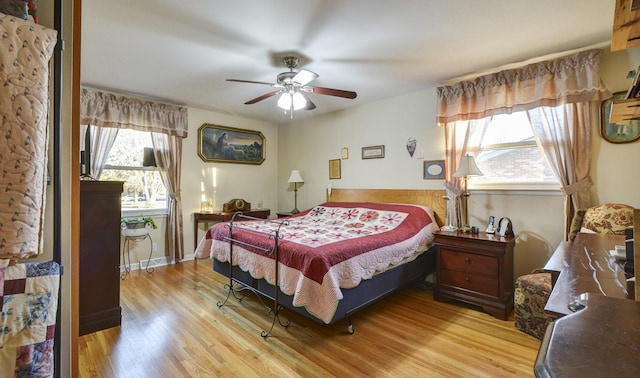 bedroom with light wood-style flooring and ceiling fan