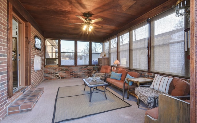 sunroom / solarium with wood ceiling and a ceiling fan