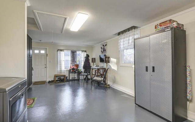 interior space with attic access, crown molding, baseboards, and concrete flooring