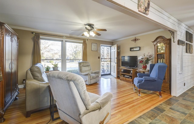 living area with a ceiling fan, crown molding, and wood finished floors