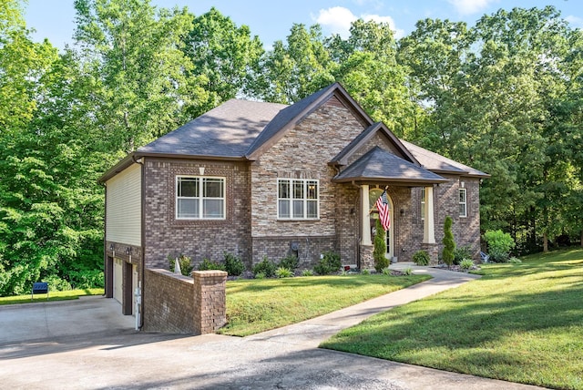 craftsman-style home featuring an attached garage, brick siding, concrete driveway, stone siding, and a front yard