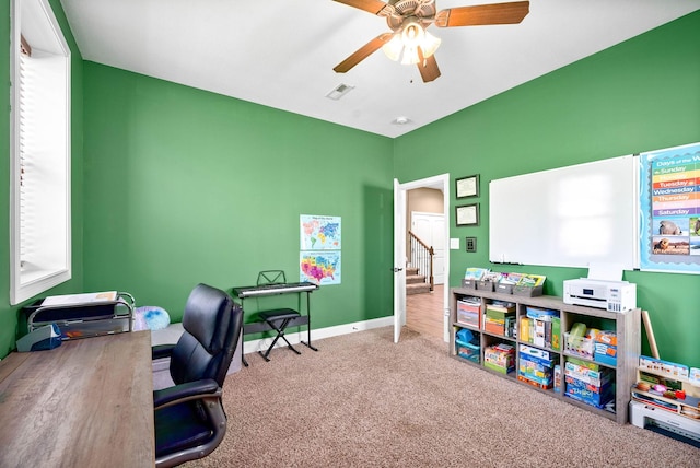 carpeted home office with baseboards, visible vents, and a ceiling fan