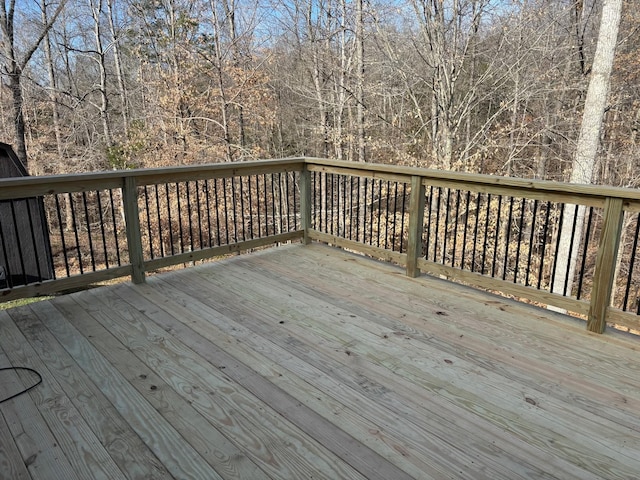 wooden deck featuring a view of trees