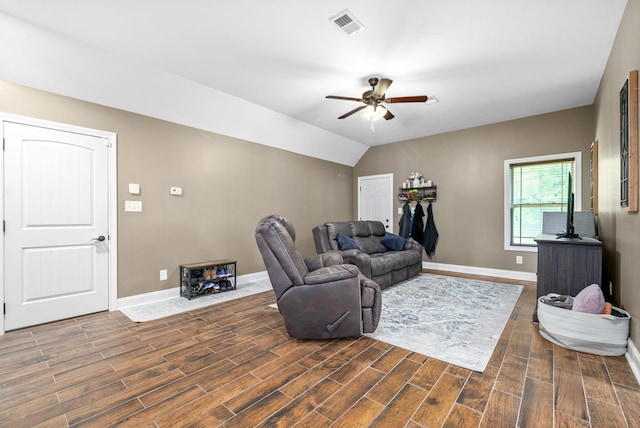 living room featuring baseboards, visible vents, vaulted ceiling, and wood finished floors