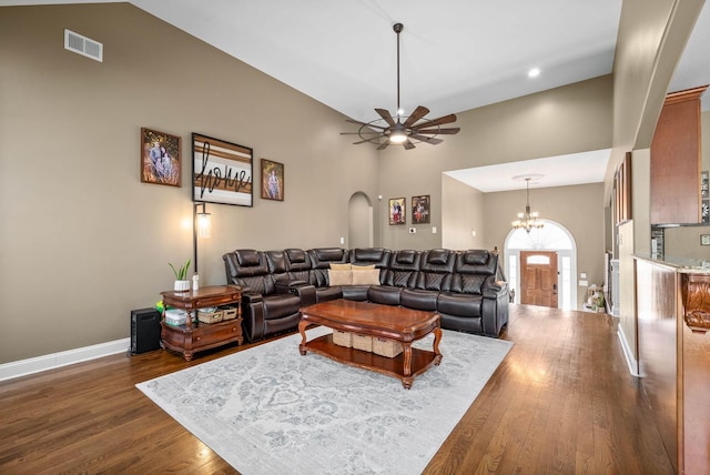 living room with baseboards, visible vents, arched walkways, and dark wood-type flooring