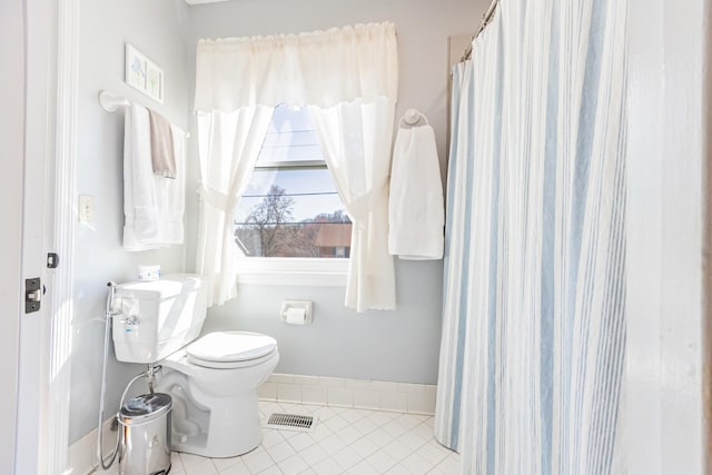 bathroom with toilet, visible vents, and tile patterned floors