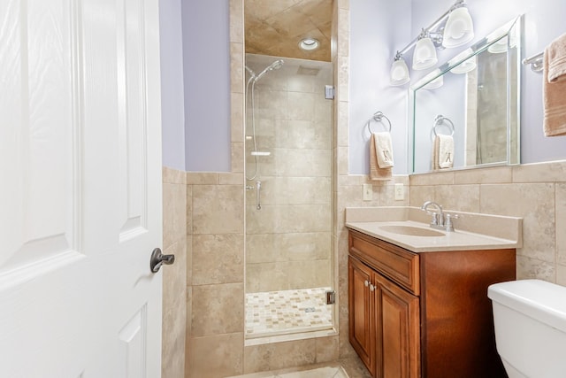 full bathroom featuring toilet, a shower stall, and tile walls