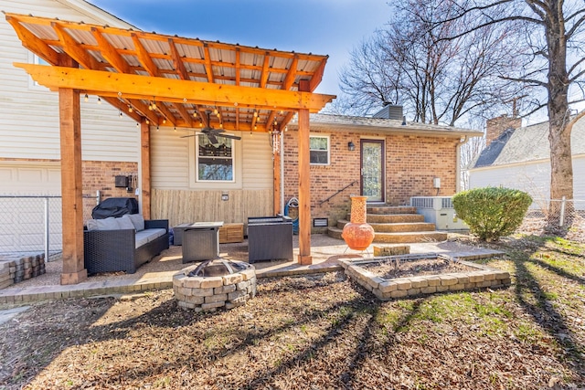 exterior space with brick siding, central AC unit, an outdoor fire pit, a patio area, and fence