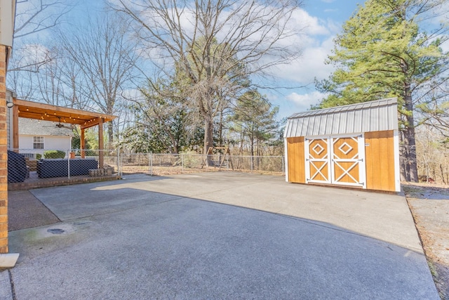 exterior space with ceiling fan, a shed, an outdoor structure, and fence