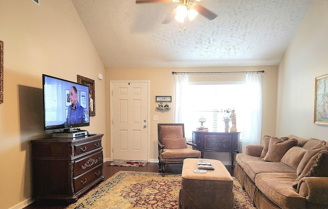 living room featuring a textured ceiling, vaulted ceiling, wood finished floors, and ceiling fan