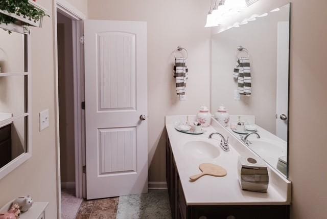 bathroom featuring double vanity and a sink