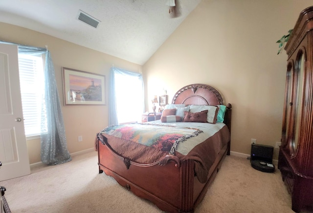 bedroom featuring vaulted ceiling, light colored carpet, visible vents, and baseboards