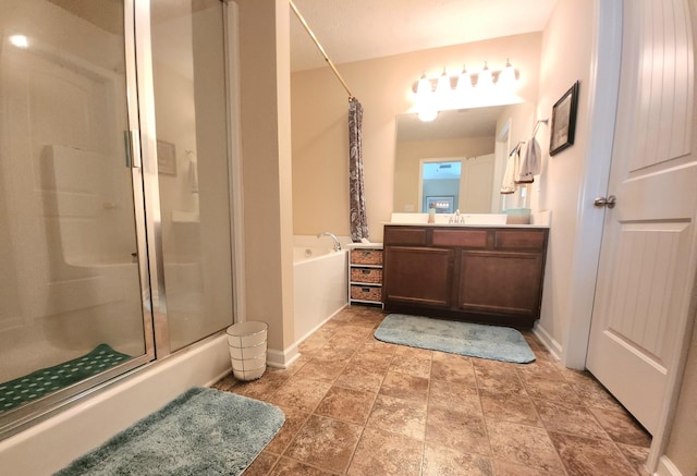 bathroom featuring vanity, a bath, baseboards, and a stall shower