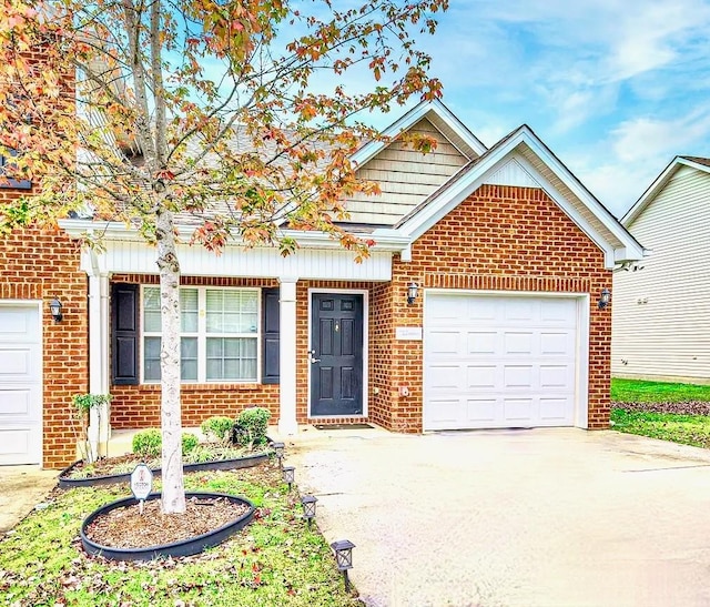 view of front of home with concrete driveway, brick siding, and a garage