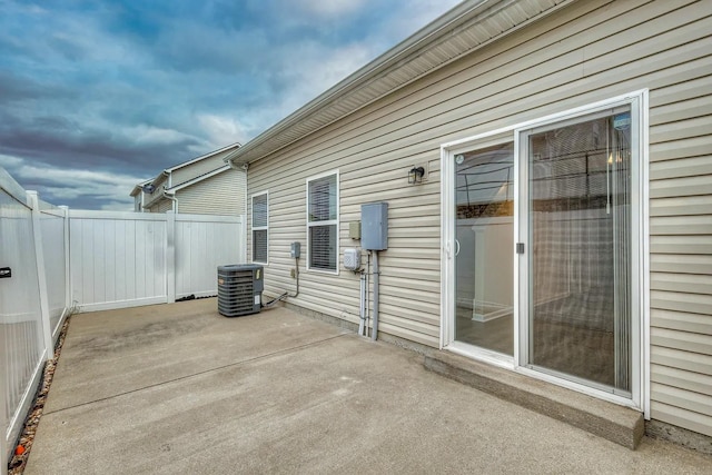 view of patio with cooling unit and fence