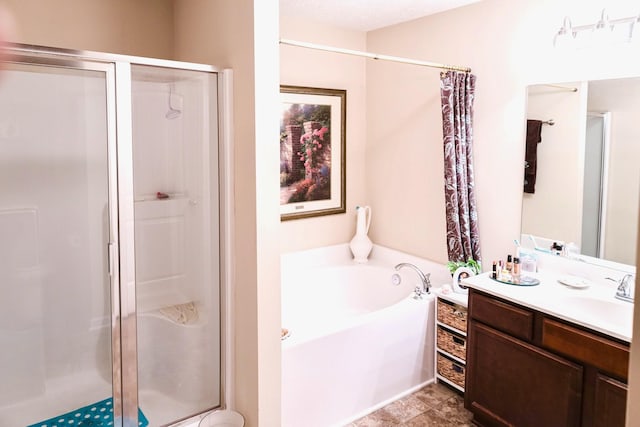 bathroom featuring a stall shower, vanity, and a garden tub