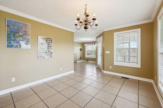 spare room with a chandelier, light tile patterned flooring, visible vents, baseboards, and ornamental molding