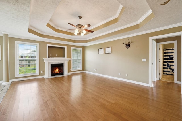 unfurnished living room with crown molding, a textured ceiling, a ceiling fan, and light wood-style flooring
