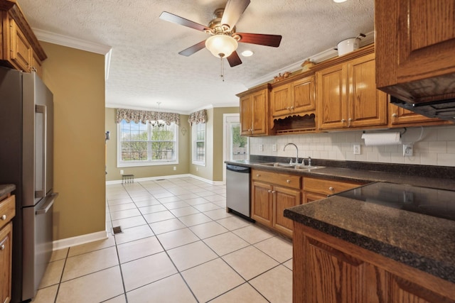 kitchen with stainless steel appliances, backsplash, crown molding, and a sink