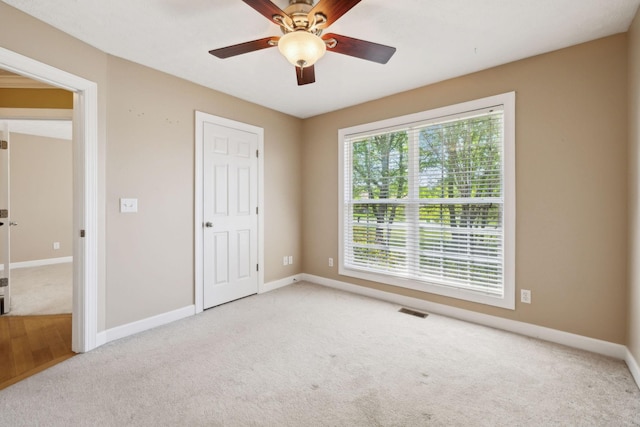 unfurnished bedroom featuring visible vents, ceiling fan, carpet flooring, and baseboards
