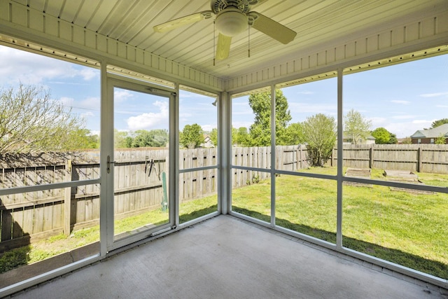 unfurnished sunroom with ceiling fan