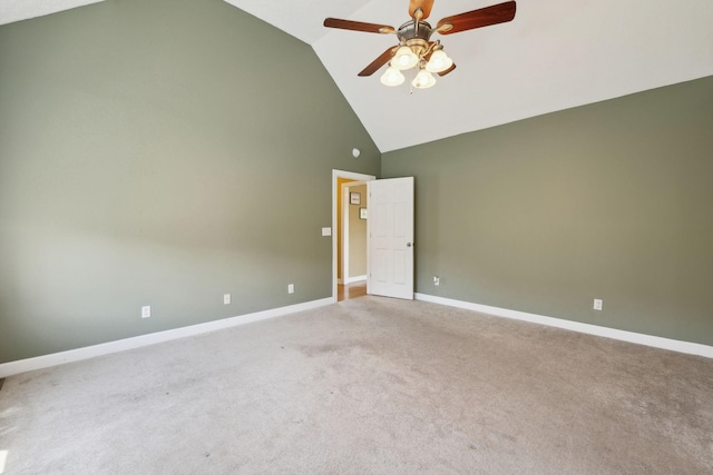 empty room with high vaulted ceiling, ceiling fan, carpet floors, and baseboards
