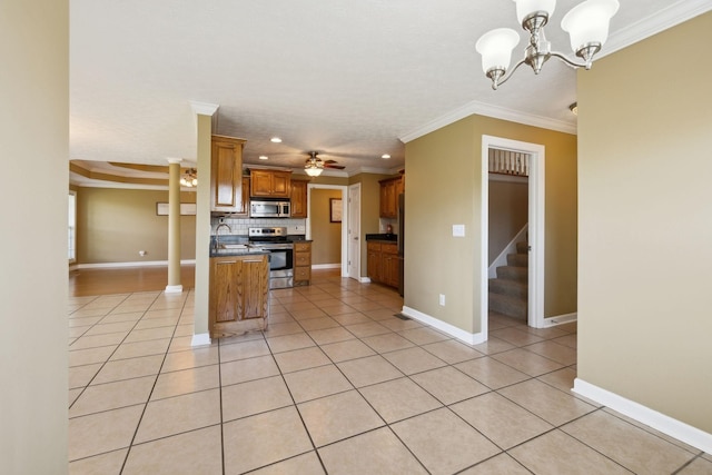 kitchen with light tile patterned floors, dark countertops, stainless steel appliances, recessed lighting, and ornamental molding