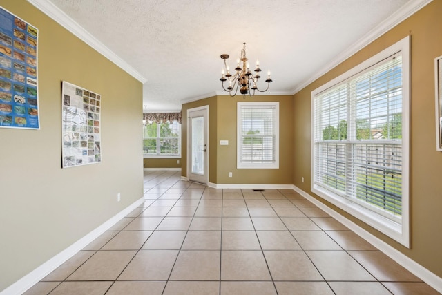 unfurnished dining area with an inviting chandelier, light tile patterned floors, crown molding, baseboards, and a textured ceiling