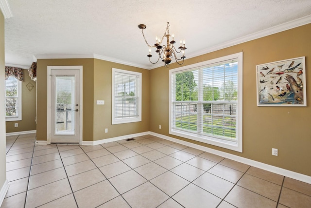 unfurnished dining area featuring crown molding, an inviting chandelier, a wealth of natural light, and baseboards