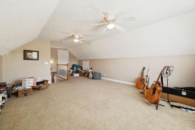playroom with baseboards, a ceiling fan, lofted ceiling, and carpet