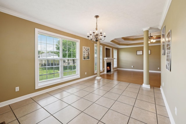 unfurnished room featuring light tile patterned floors, baseboards, ornamental molding, and decorative columns