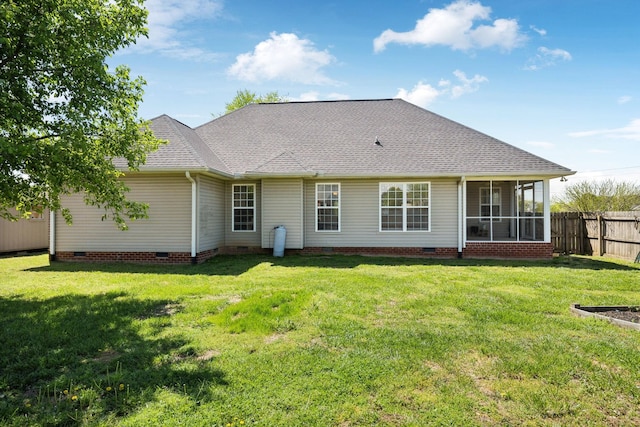 rear view of property with fence, a shingled roof, a yard, and crawl space